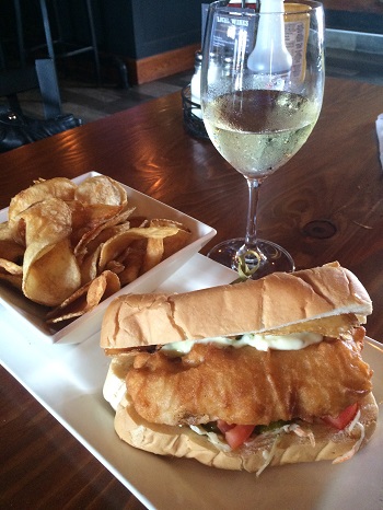 A glass of local Chardonnay and a fish hoagie at Billy's Taphouse in Windsor/Essex.